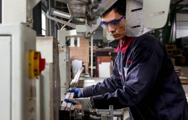 Alumiinituotteiden parissa työskentelevä työntekijä Zoupingin tehtaalla Kiinan itäisessä Shandongin maakunnassa