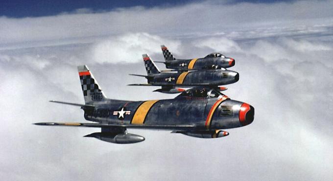 Kolme F-86-saber-hävittäjää lentämässä muodostelmassa.