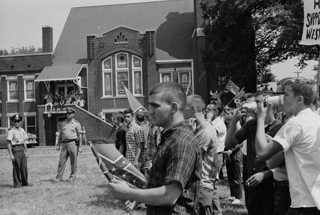 Joukko oppilaita Woodlawn High Schoolissa Birminghamissa, Alabamassa, lipumassa konfederaation lippua vastustaen Birminghamin kampanjan alkamista toukokuussa 1963